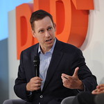 peter thiel gestures from a podium at a conference