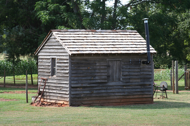 A distant photo of a tool shed.