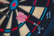 A dart on a dart board largely misses the bull's-eye  target.