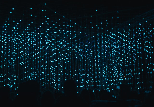 Vertical lines of diffuse blue lights on a dark background