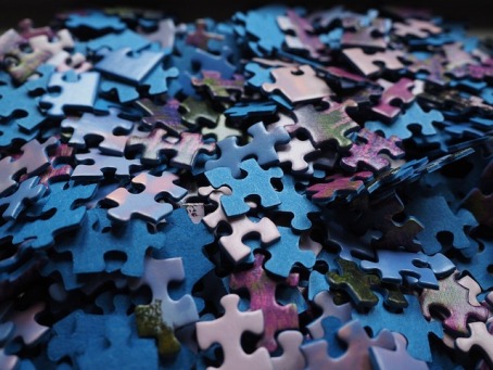 A pile of puzzle pieces are scattered.