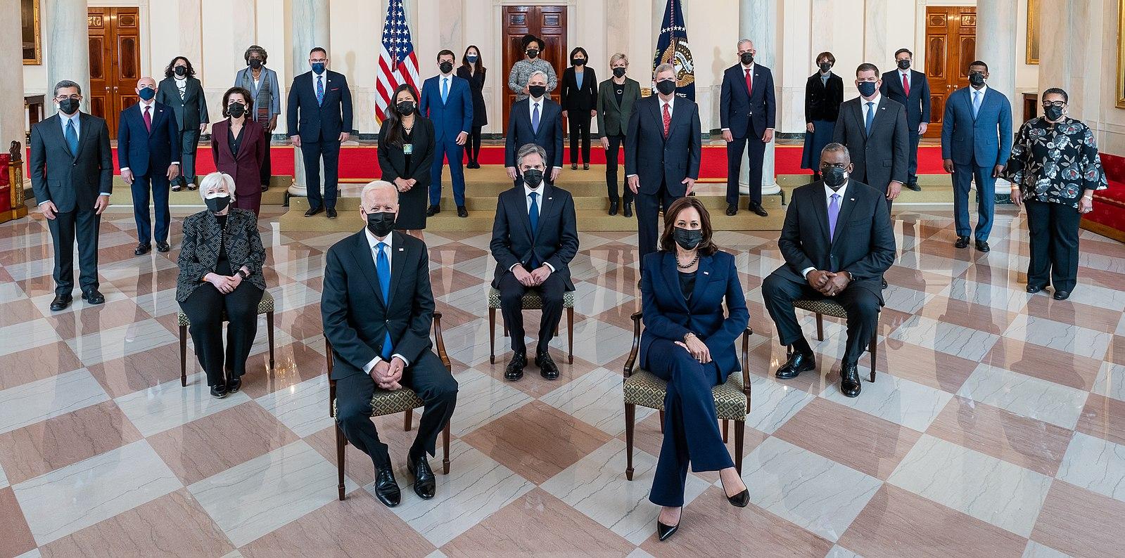 President Biden's Cabinet members sitting in chairs and wearing masks