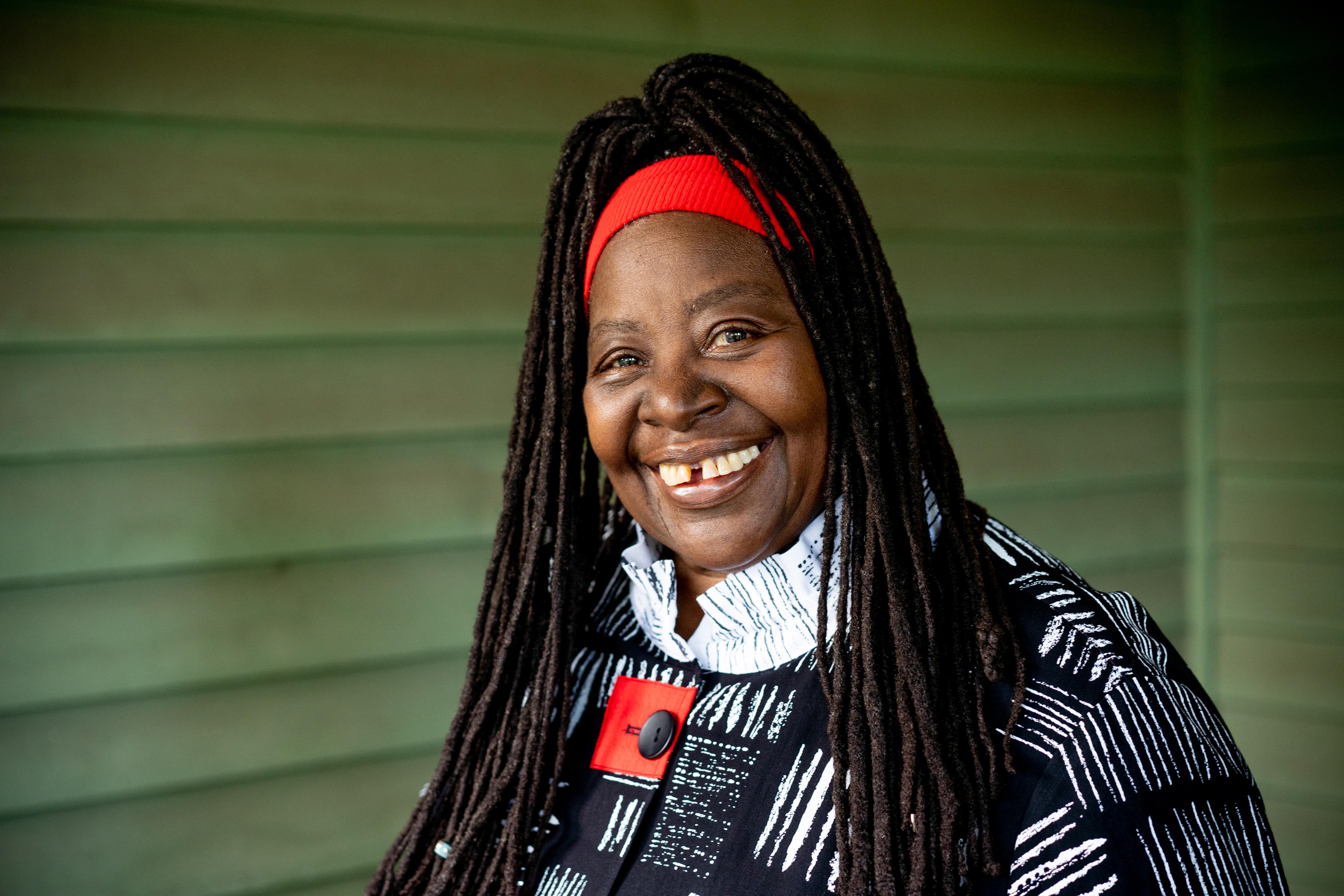 a headshot of Loretta Ross on a green background