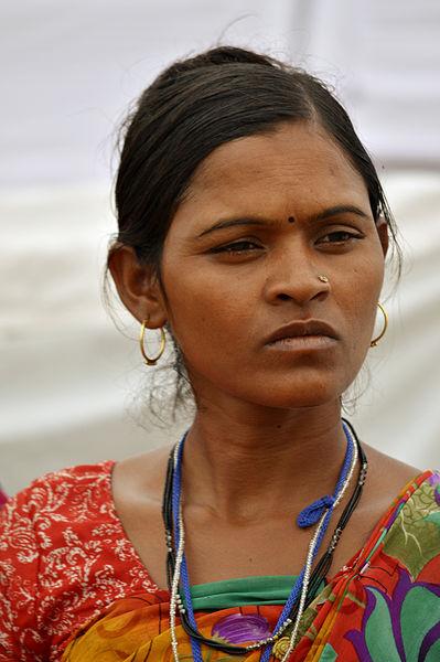 An Indian woman gazes into the distance and appears to be thinking.