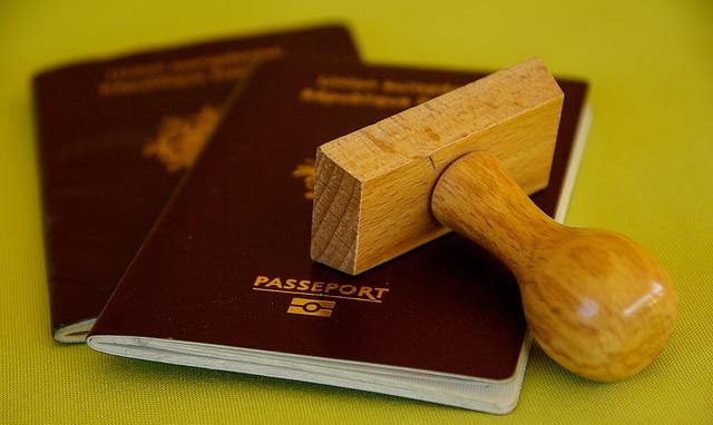 Two generic passports are covered by a stamp block turned on its side.