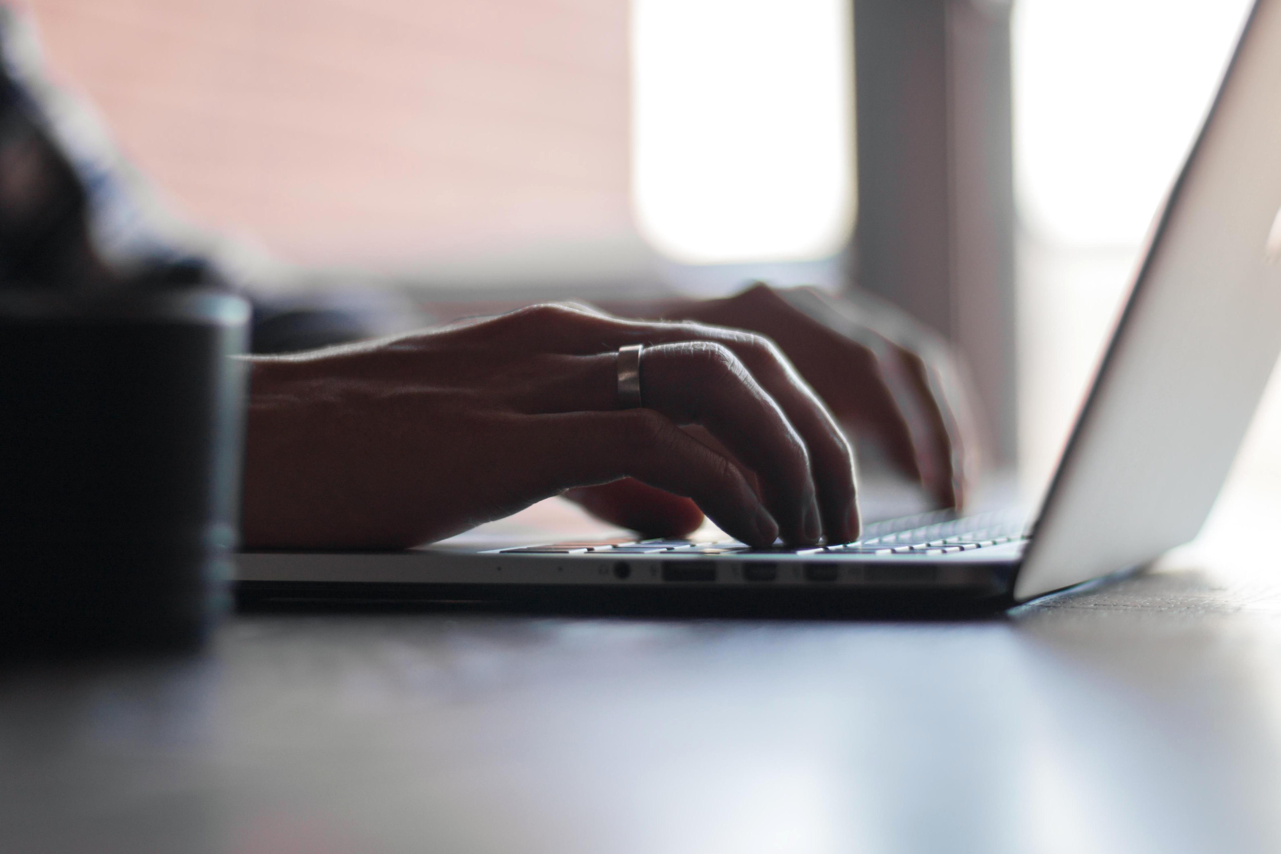 person typing on computer