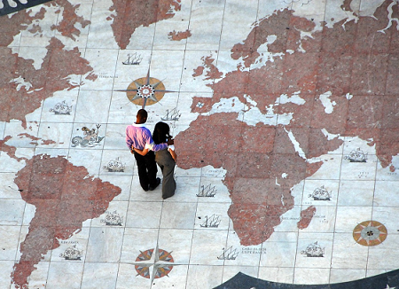 Couple standing on a world map