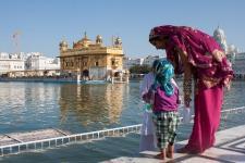 A woman and child stand in front of Sri Harmandir Sahib aka the Golden Temple in Amritsar, India. (Pixabay)