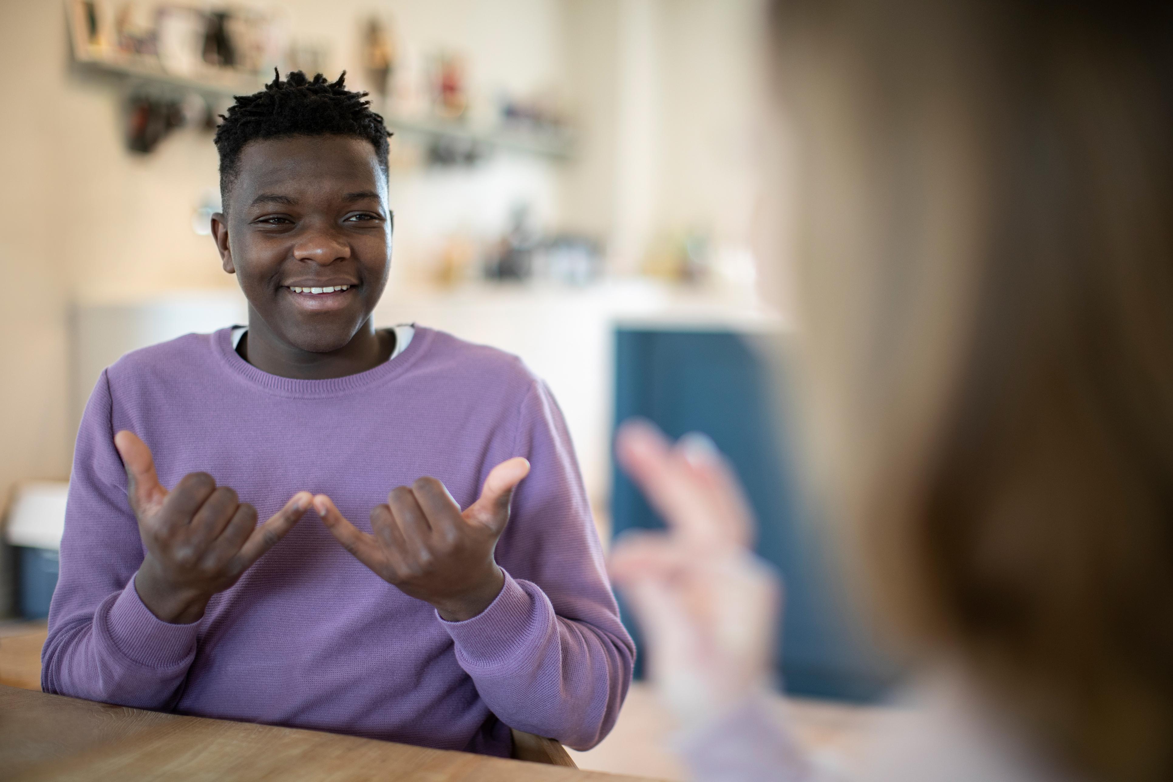 Teen-age boy and girl having a conversation in sign language