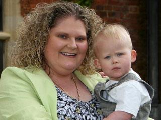 Louise Brown, the world's first test-tube baby, holds her son.