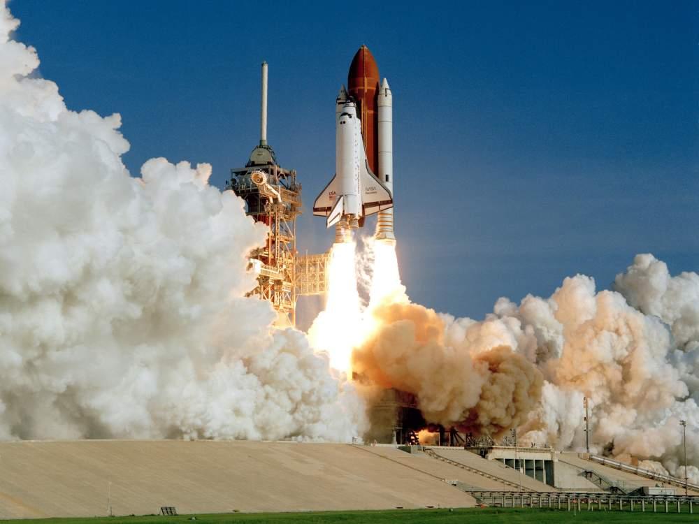 NASA spaceship taking off, smoke surrounding the ship